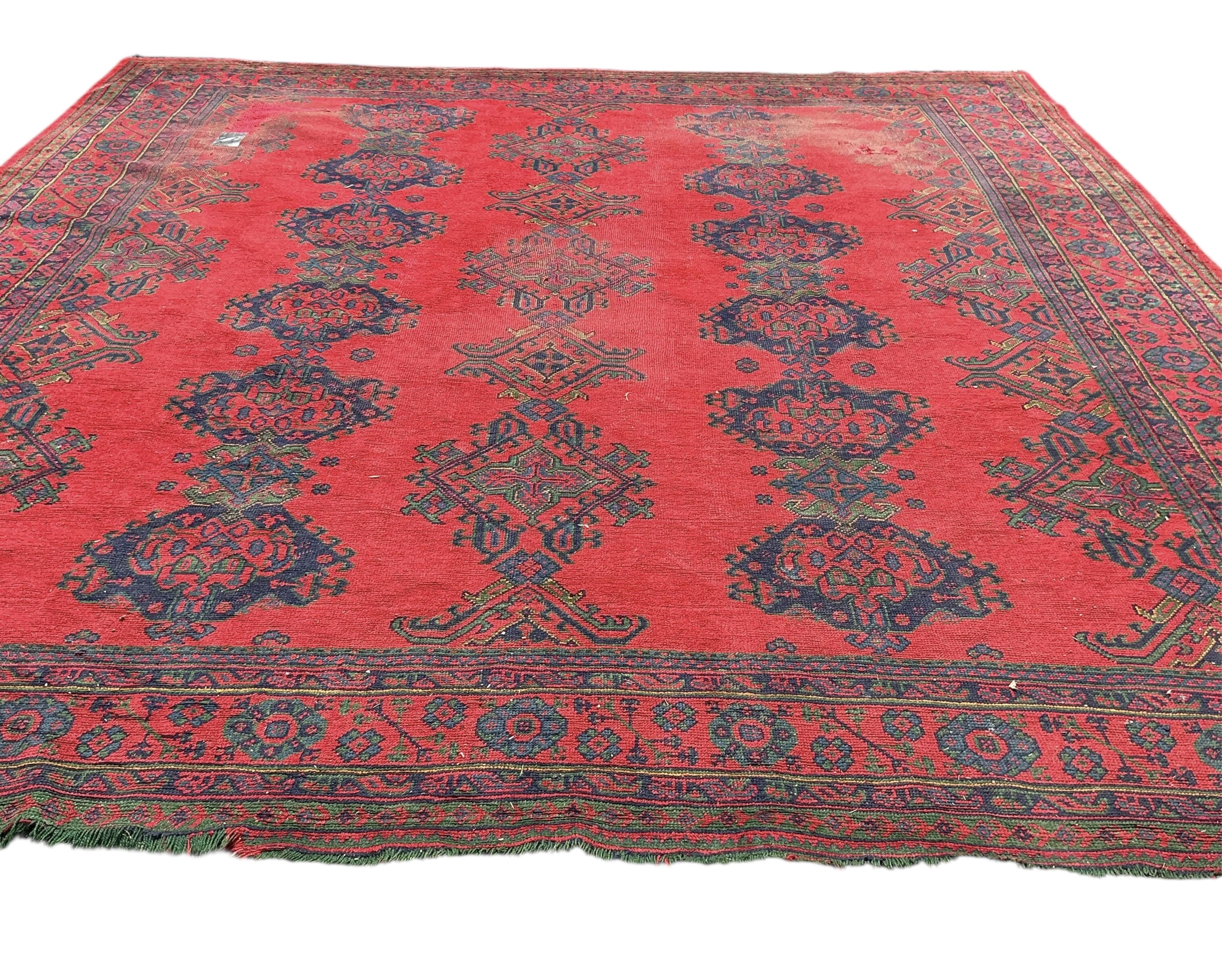 An early 20th century Afghan red ground carpet, 445 x 375cm